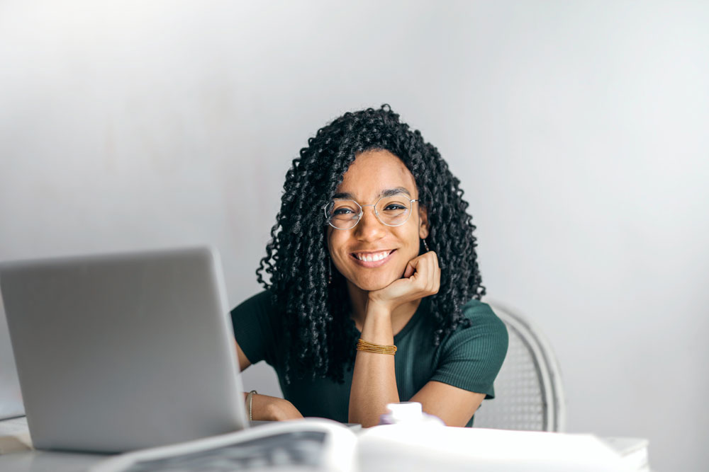 Teenage Girl Smiling at Computer